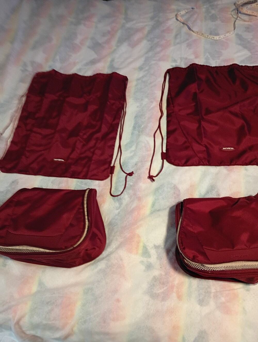 TWO SAMSONITE TRAVEL SETS IN BURGUNDY RED